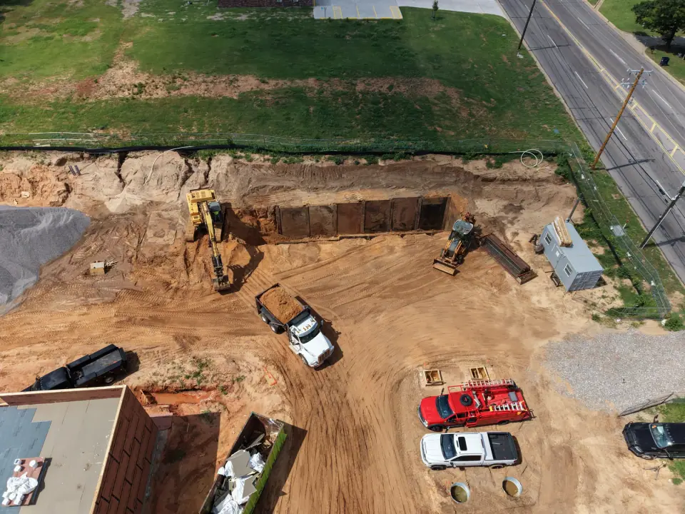 Tank-pit excavation with Scissortail trucks staged on site