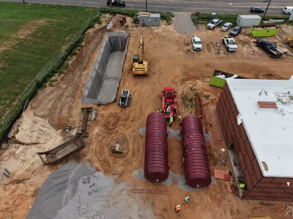 Two underground storage tanks staged beside the store before setting
