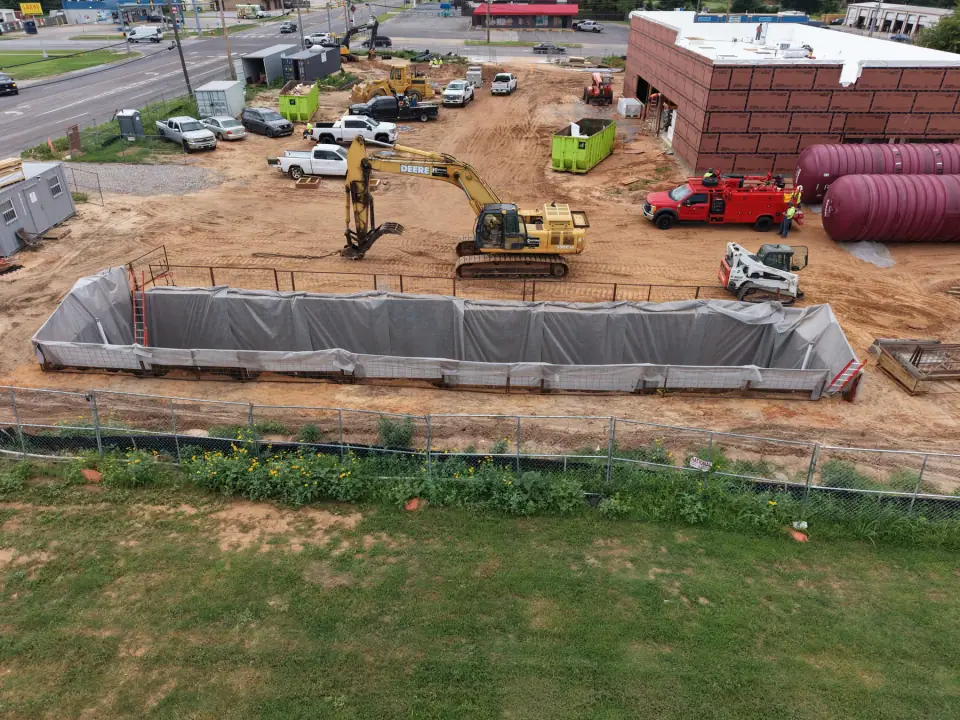 Prepared tank pit with both tanks staged nearby
