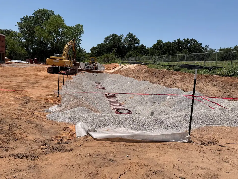 Backfilled tank area with manways and survey stakes