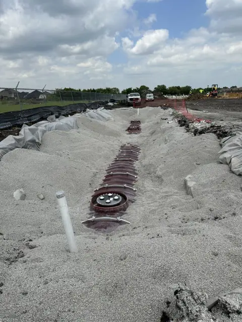 Tank manway exposed in the backfilled tank pit