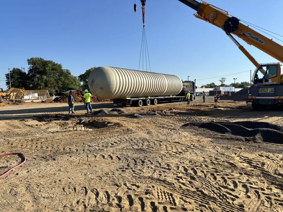 Crane rigging up to lift a tank from the trailer