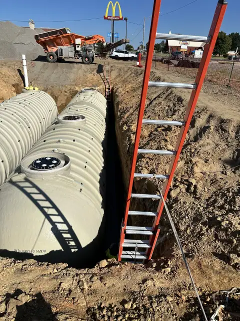 Tanks set in the excavation with ladder access