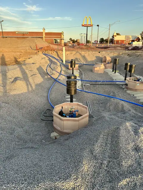 Tank sumps and risers with product piping at the tank pit
