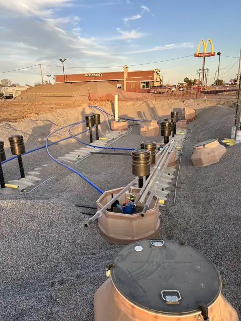 Tank-top sumps and fill risers ahead of backfill