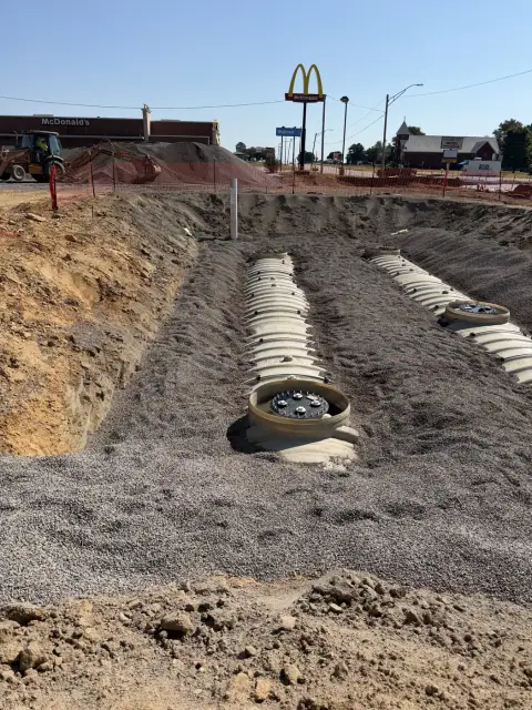 Tanks partially backfilled with manways exposed