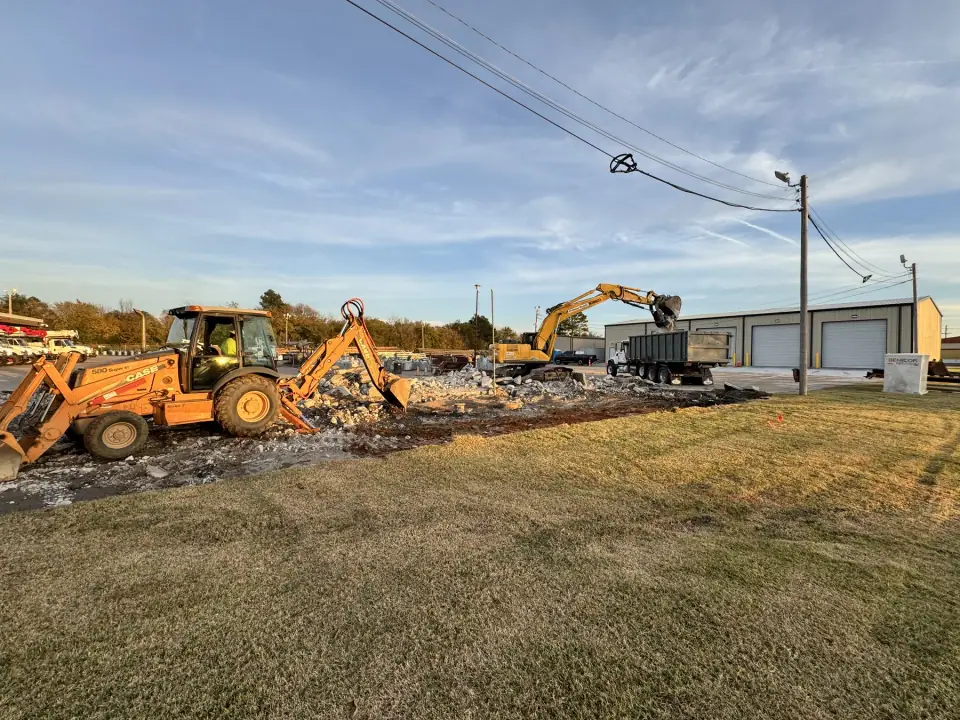 Backhoe and excavator clearing the work area