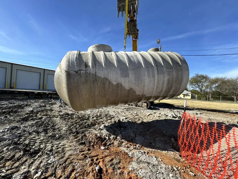 Removed underground tank lifted clear of the excavation