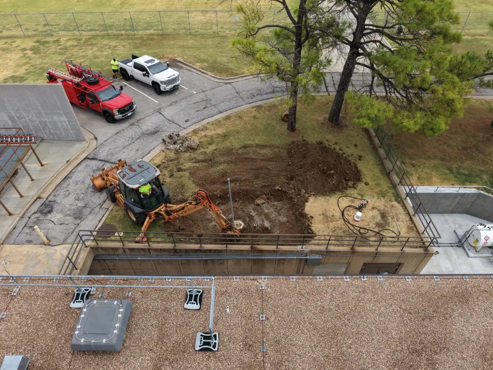 Backhoe excavating to remove the old underground tank
