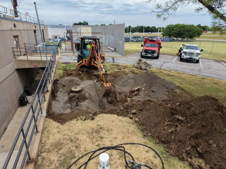Backhoe working the removal excavation along the building