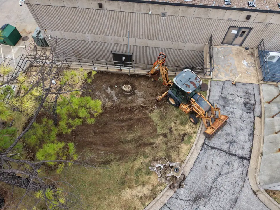 Removal excavation with the backhoe beside the building